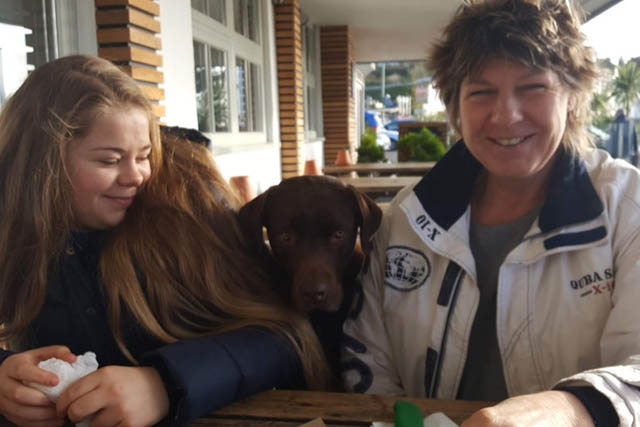 Mum, daughter and dog sat outside at the Crabshell inn in Kingsbridge.