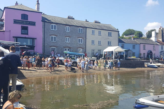 The ferry boat inn a dog friendly pub in Dittisham. View of the pub exterior with punters outside.