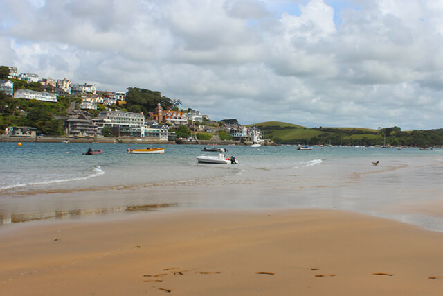 East portlemouth beach and estuary with moored boats.