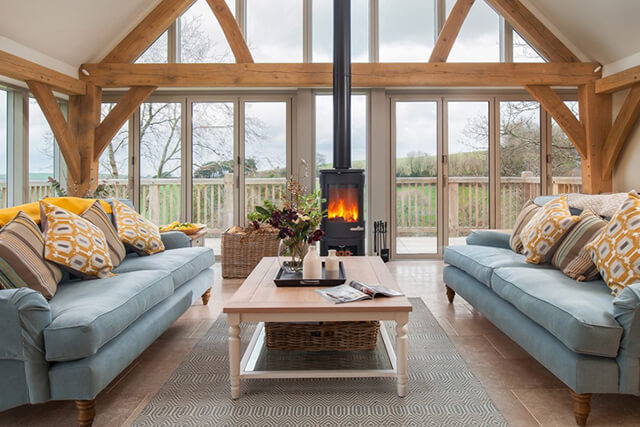 Gitcombe retreat lounge with woodburner and sofas.