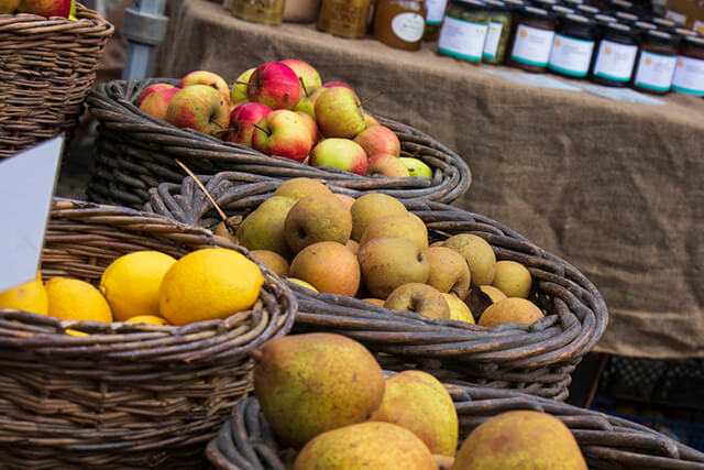Tavistock Farmers Market - apples on a table in wickar baskets.