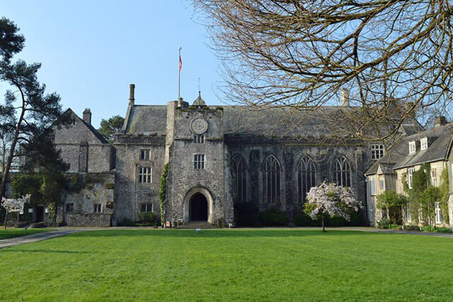 Dartington Hall estate - the great hall with lawns and blue sky.