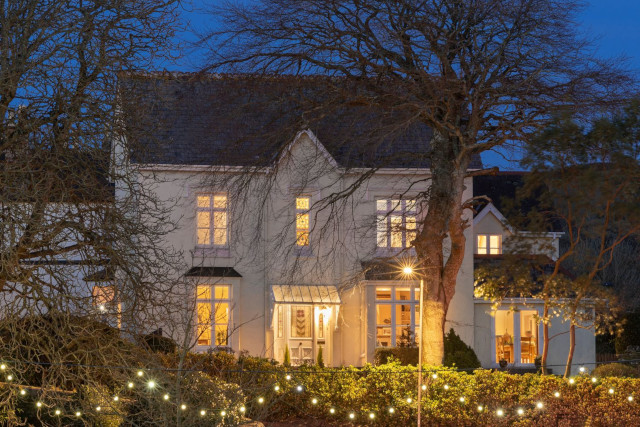 holiday home lit up with outdoor lighting