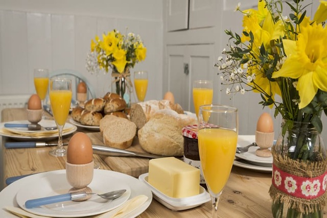 Easter Events in South Devon | Table laid with daffodils, hot cross buns and boiled eggs