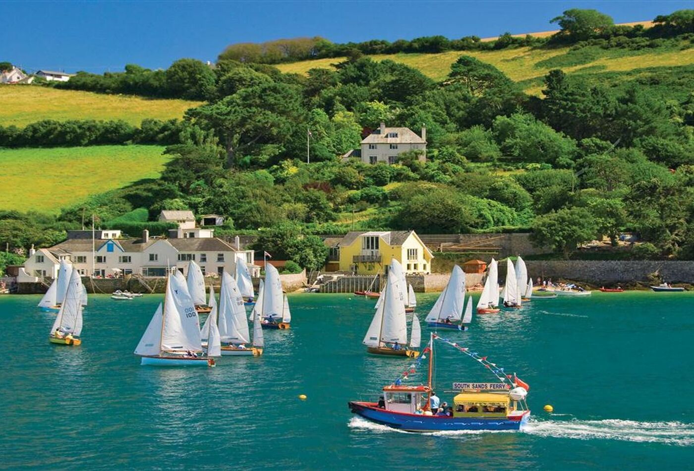Boat hire in salcombe - sailing boats enjoying the water on a summers day.
