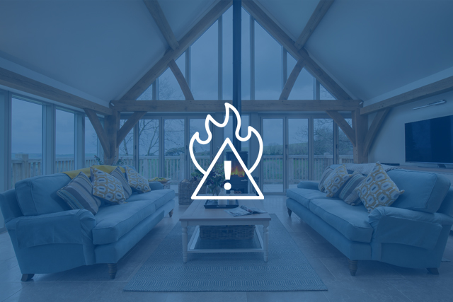 Fire hazard icon over an internal shot of a holiday cottage