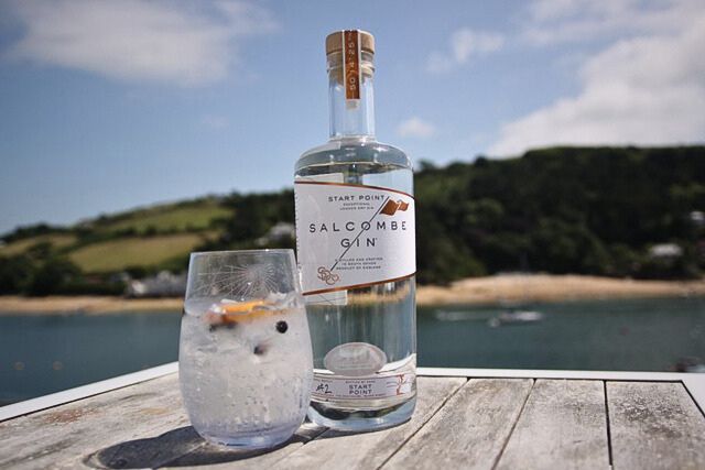 What's on in Salcombe in 2024 | A bottle of Salcombe Gin against a backdrop of the sea