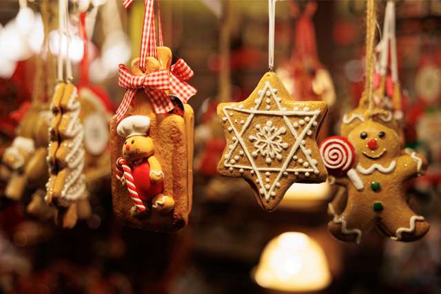 Zoomed-in shot of Christmas gingerbread tree decorations hanging with more in the background